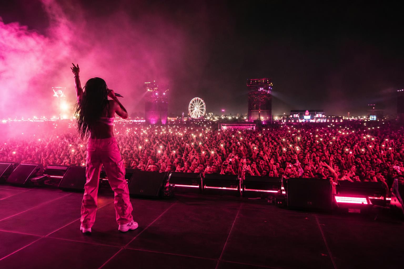 Silhouette of a female dancer mid-twerk on a smoke-filled festival stage under hot-pink lights — the visual world Megan Thee Stallion's choreography is built for
